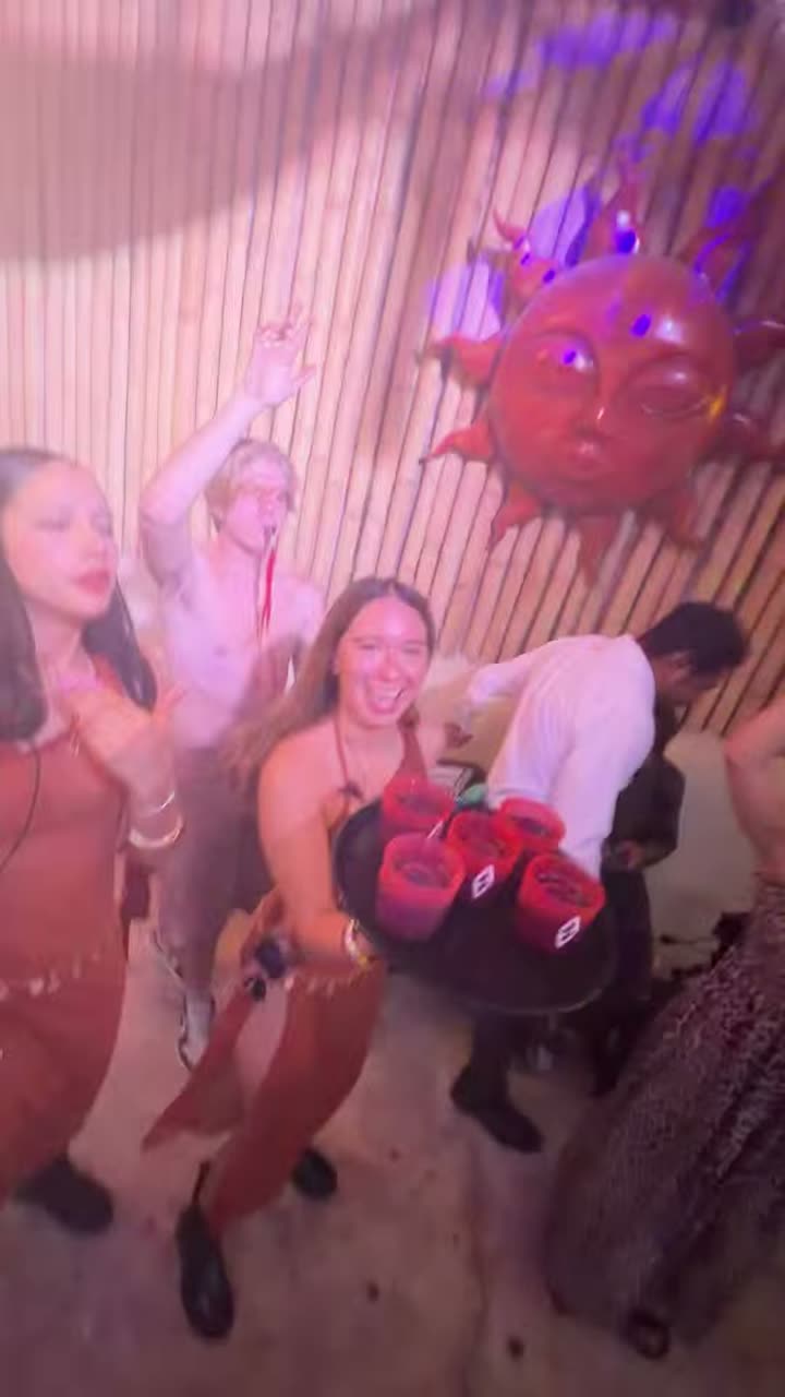 Women dancing with their hands up at a day club party