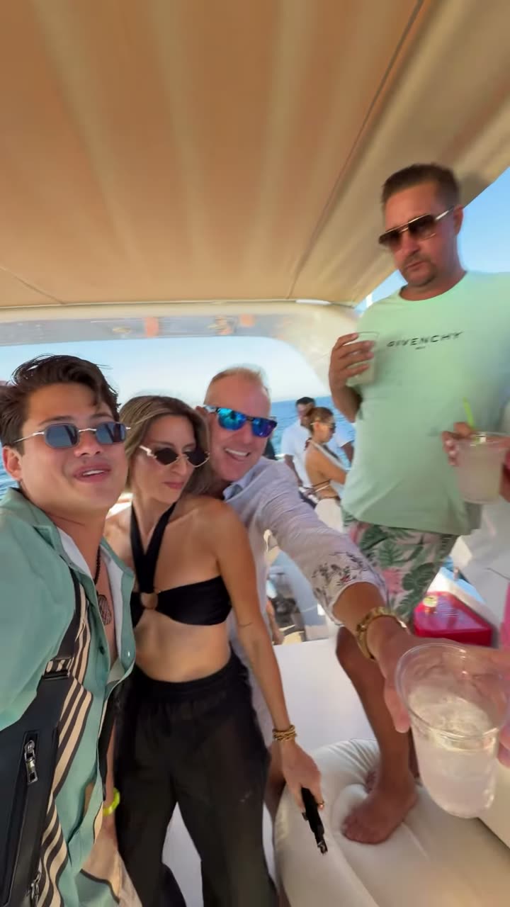 Valdi taking a selfie with guests on a yacht
